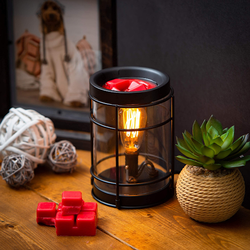 What are the advantages of candle warmers over wax candles?